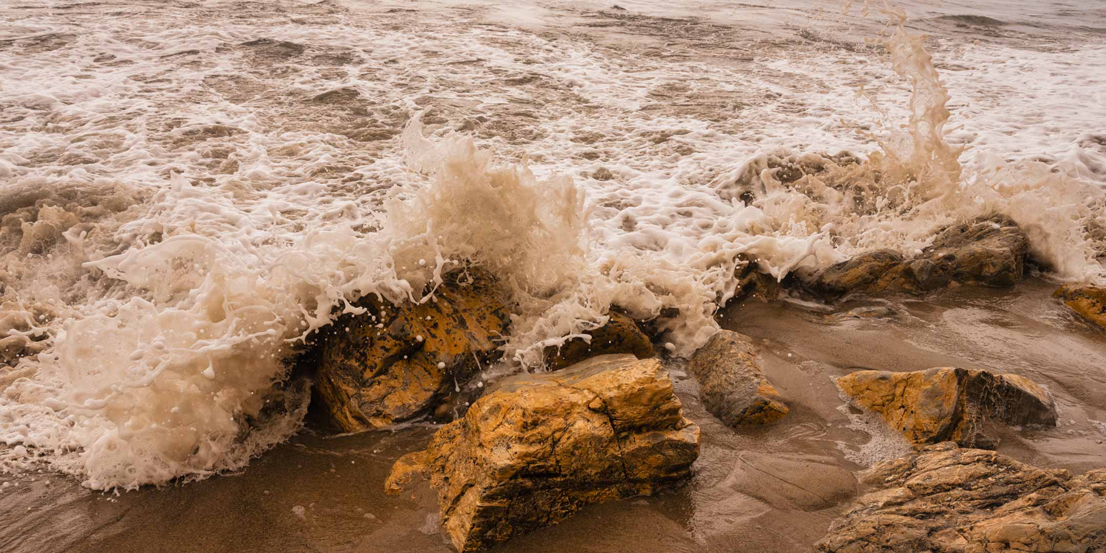 Waves crashing on rocks by the sea