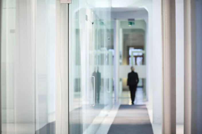 Long, bright hallway with a person at the end